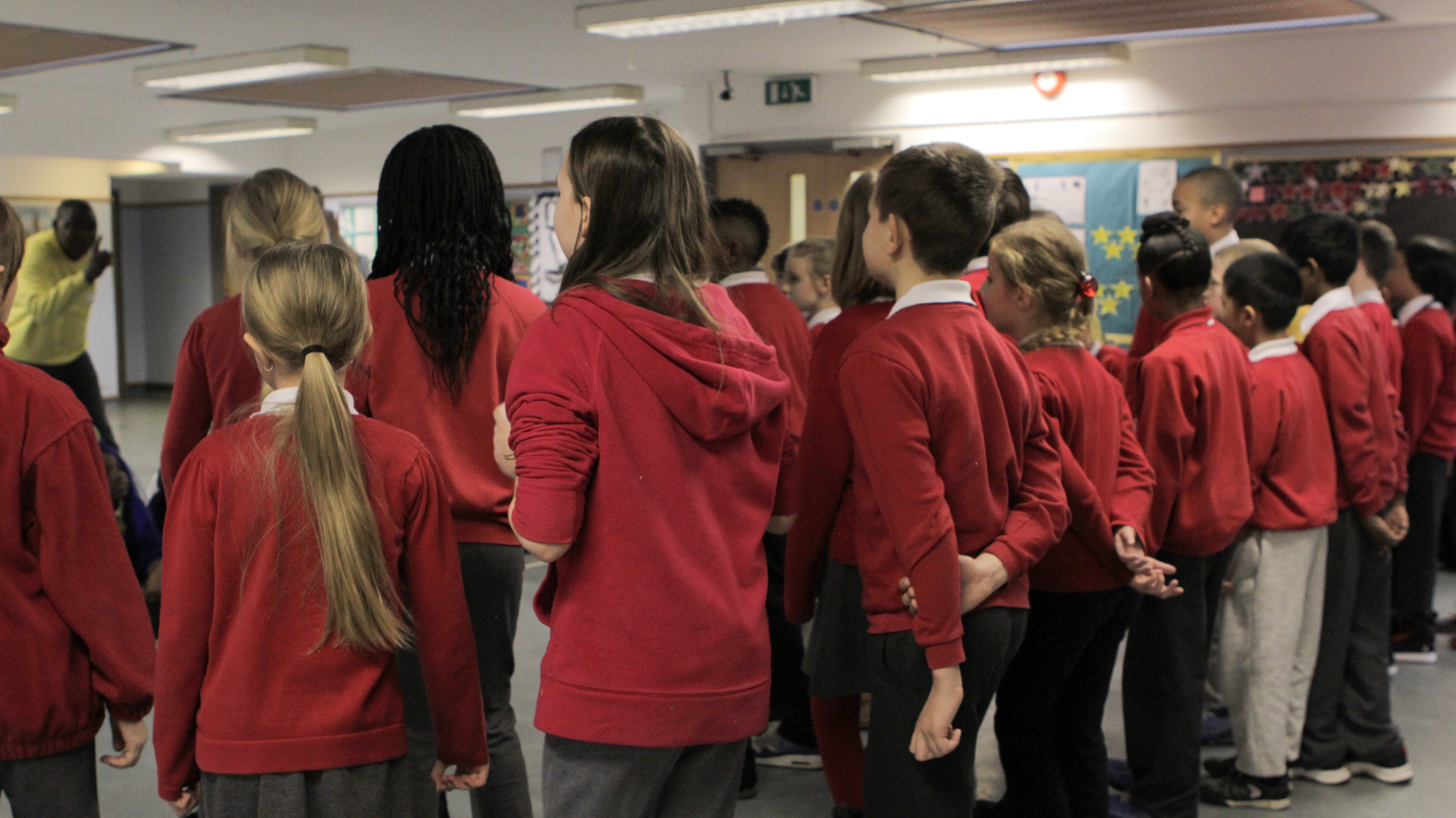 Alex Oma-Pius leads a rehearsal at Ellen Wilkinson Primary School